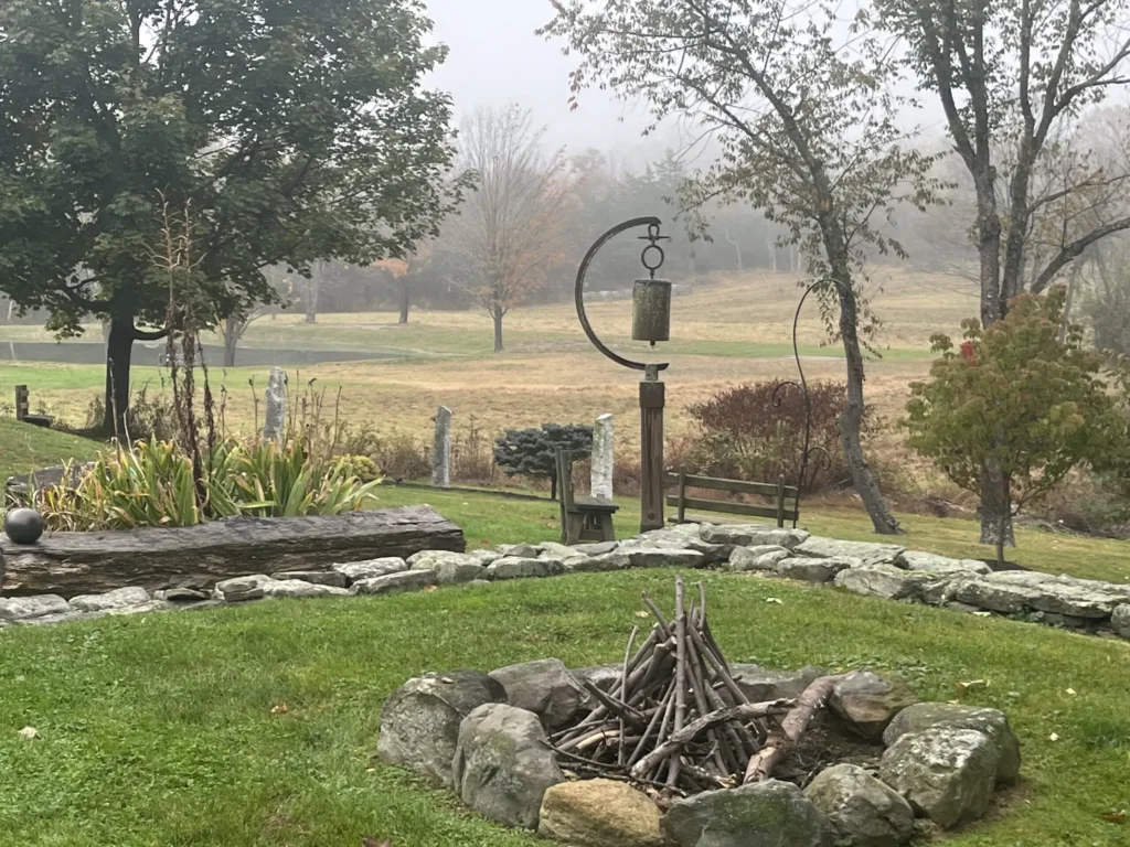 Garden landscape with trees, plants, and a small pond