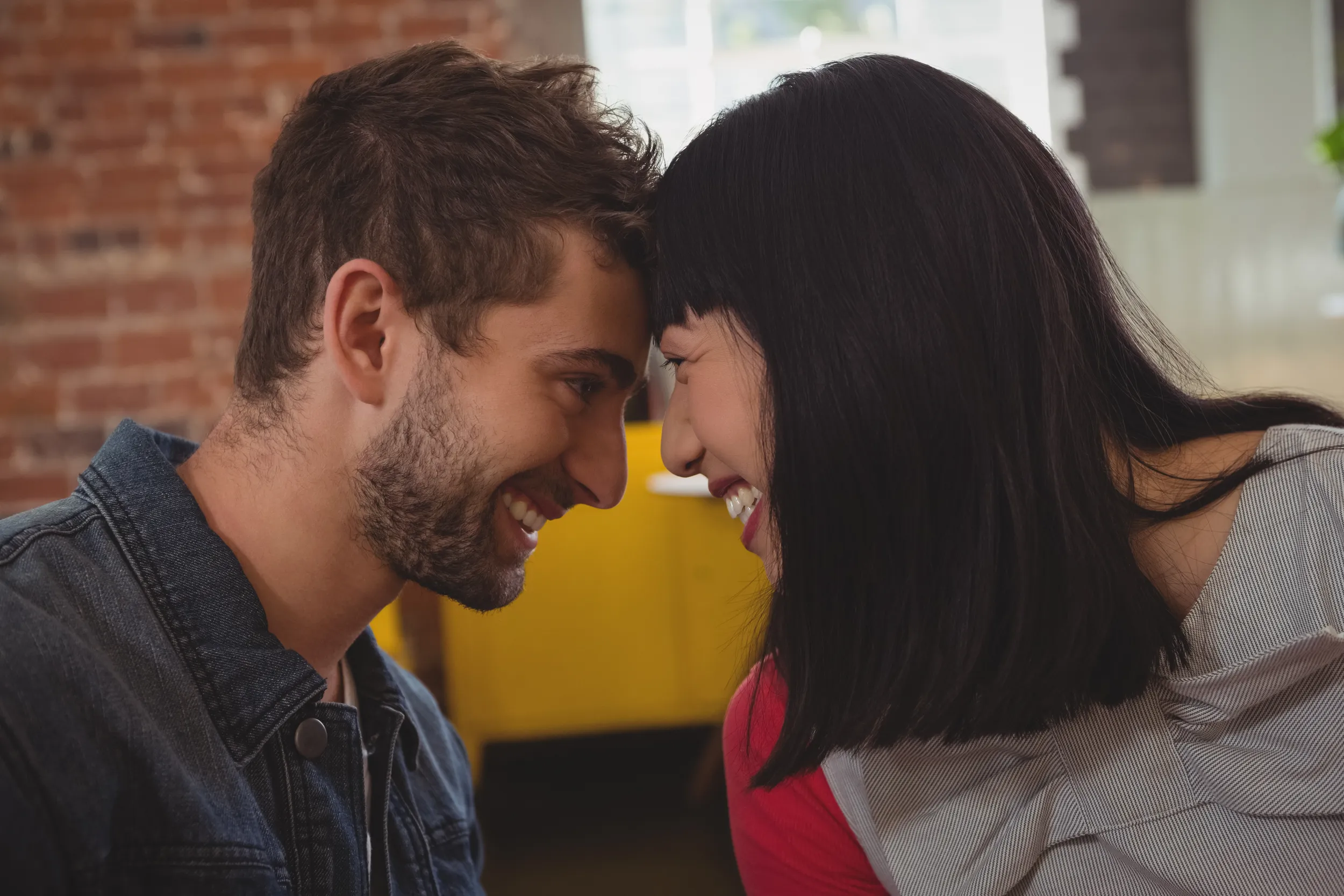 Young couple smiling with their foreheads touching