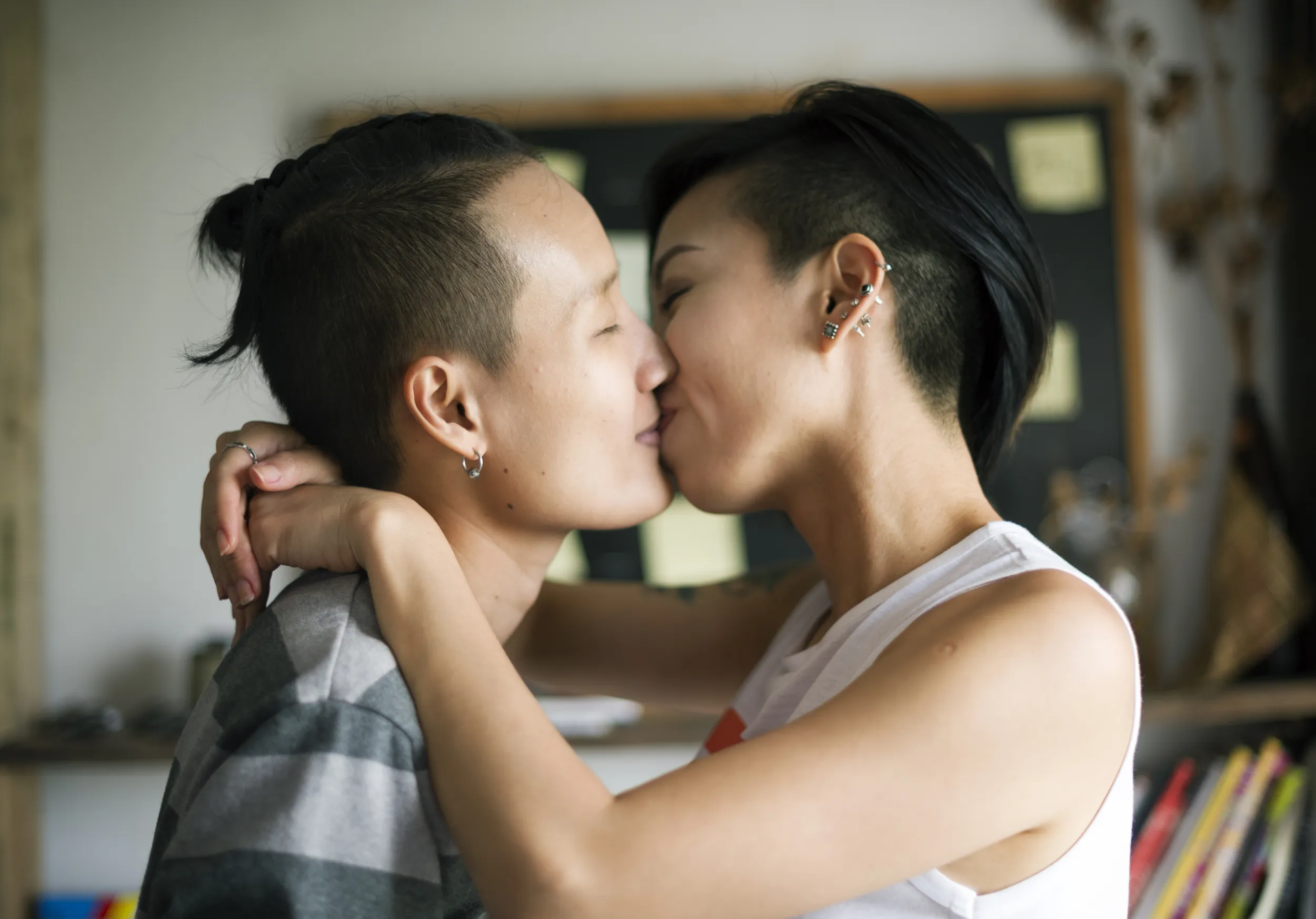Couple embracing and kissing at home